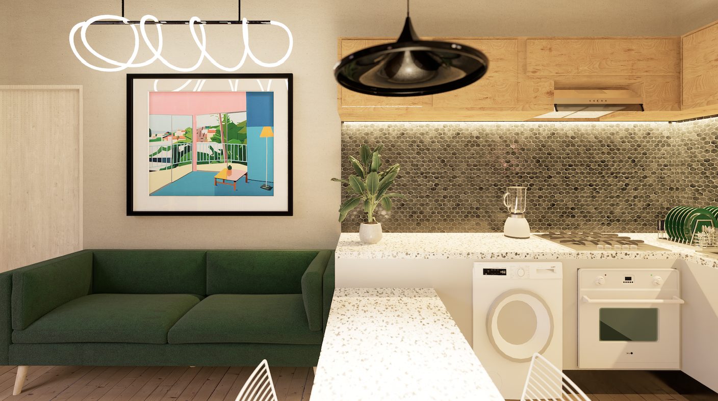 Estar con sofá verde y cocina de la casa remodelada